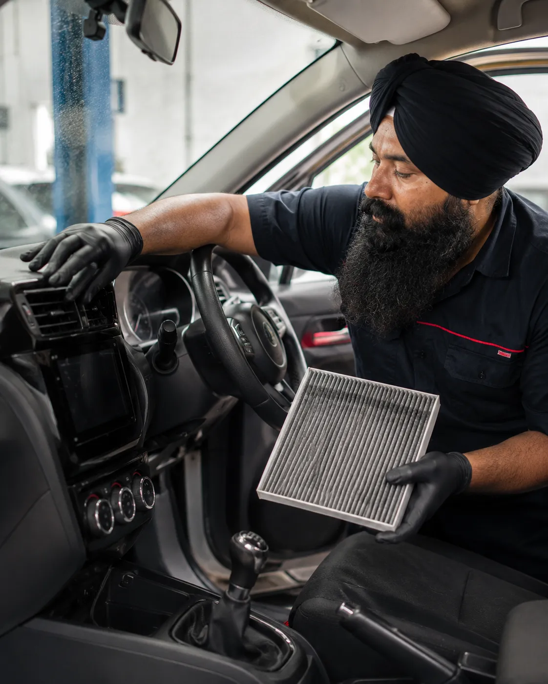 Mechanic checking cold air at the dashboard vents in Beenleigh